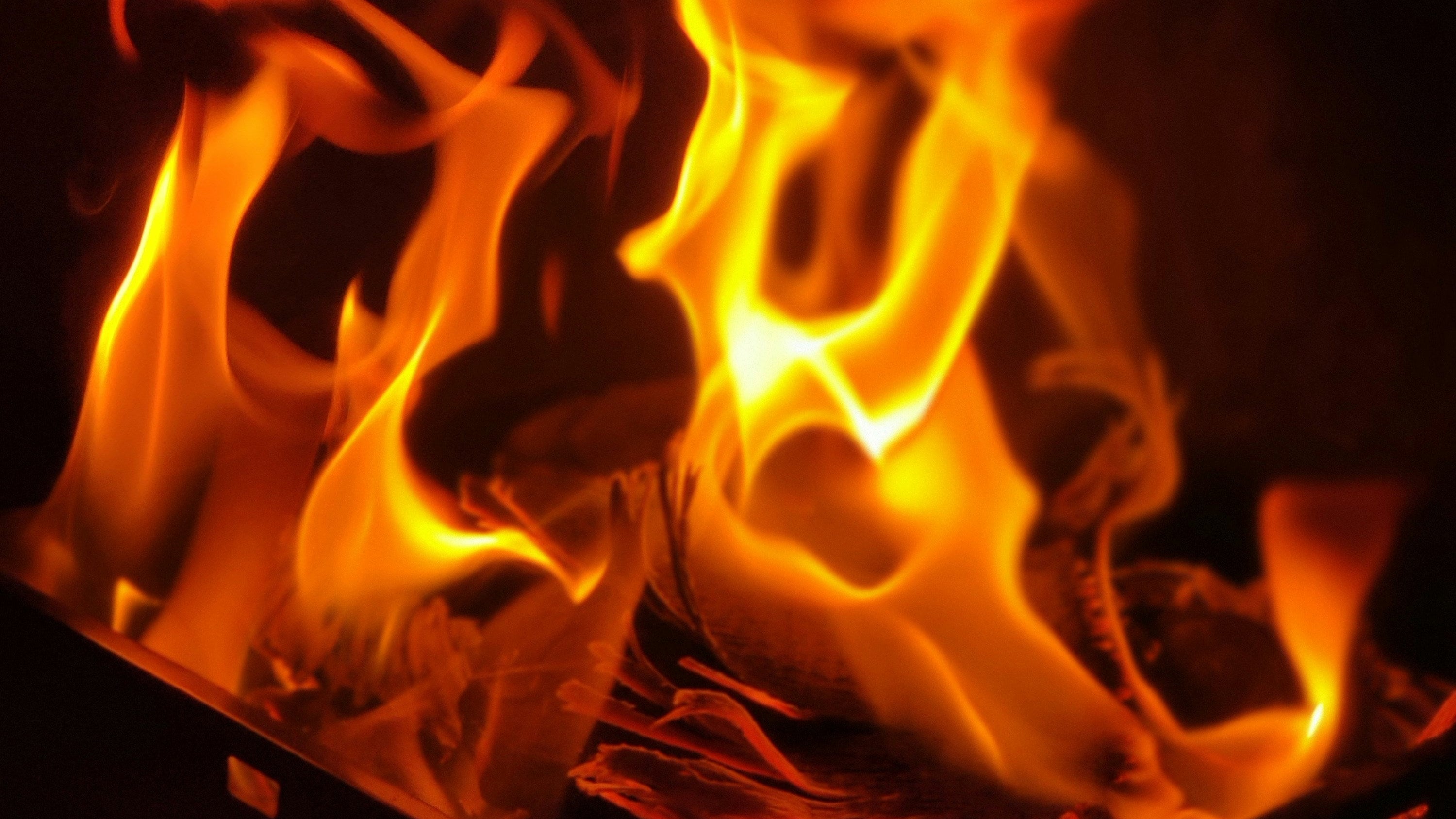 Close-up of flames burning on a dark background